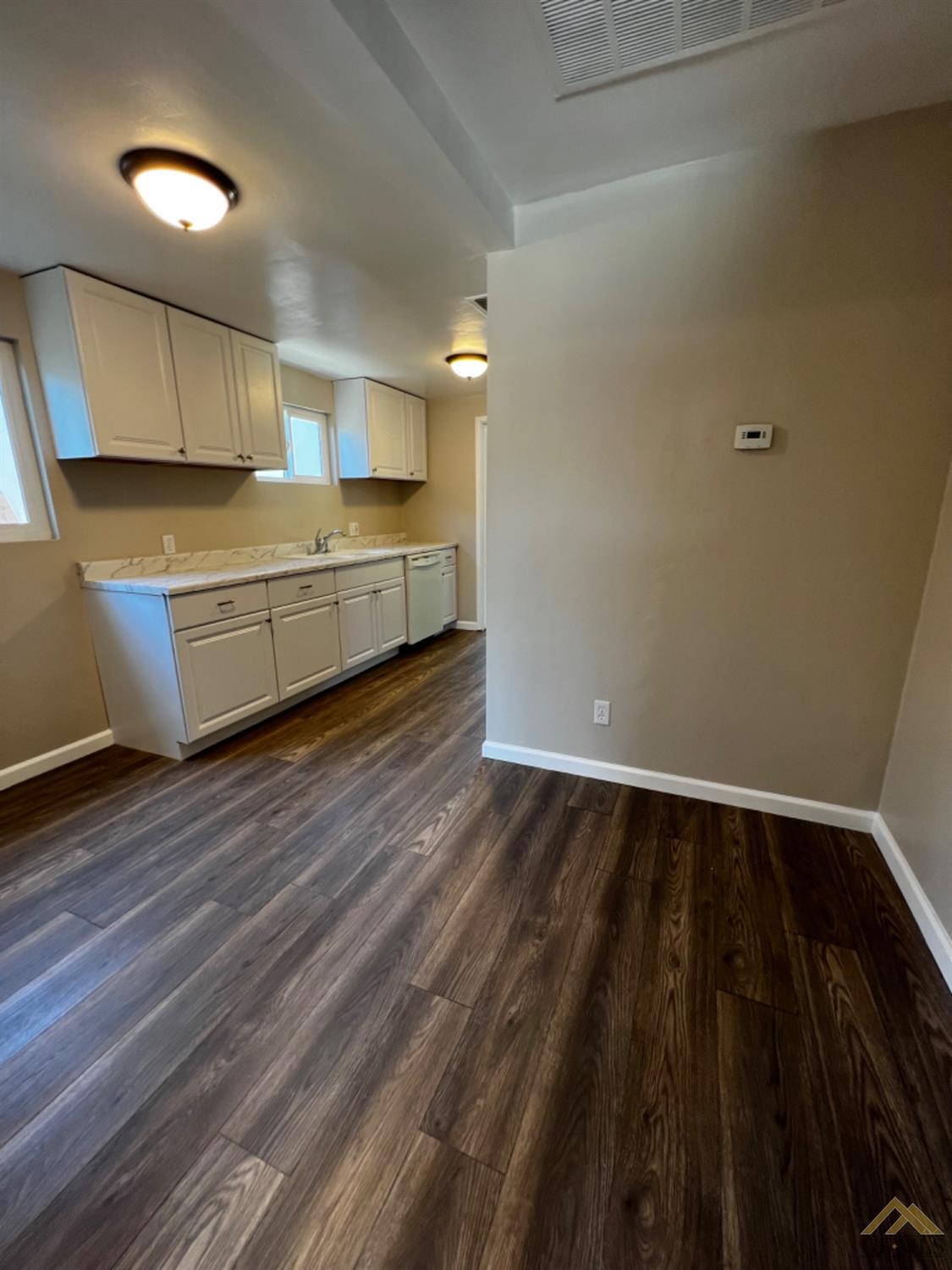 Undisclosed Address Bakersfield, CA 93304 - Photo 12 of 18 a kitchen with a sink and wooden floor