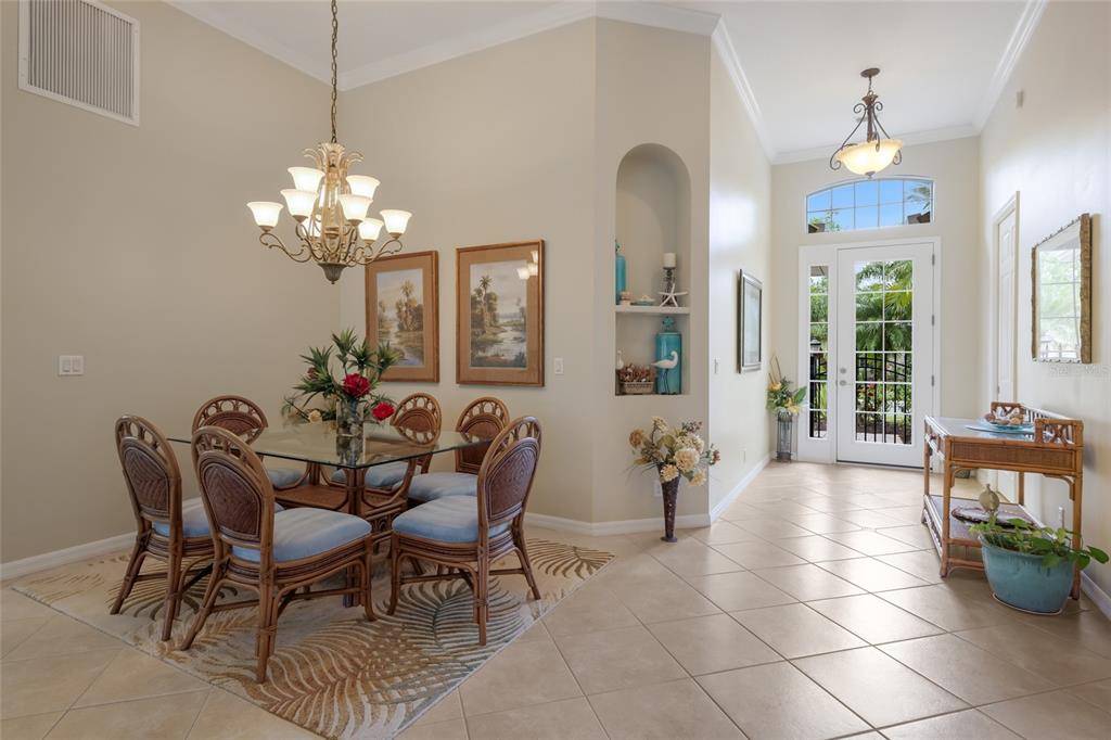 11709 Strandhill Court Lakewood Ranch, FL 34202 - Photo 11 of 51 a view of a dining room with furniture and chandelier