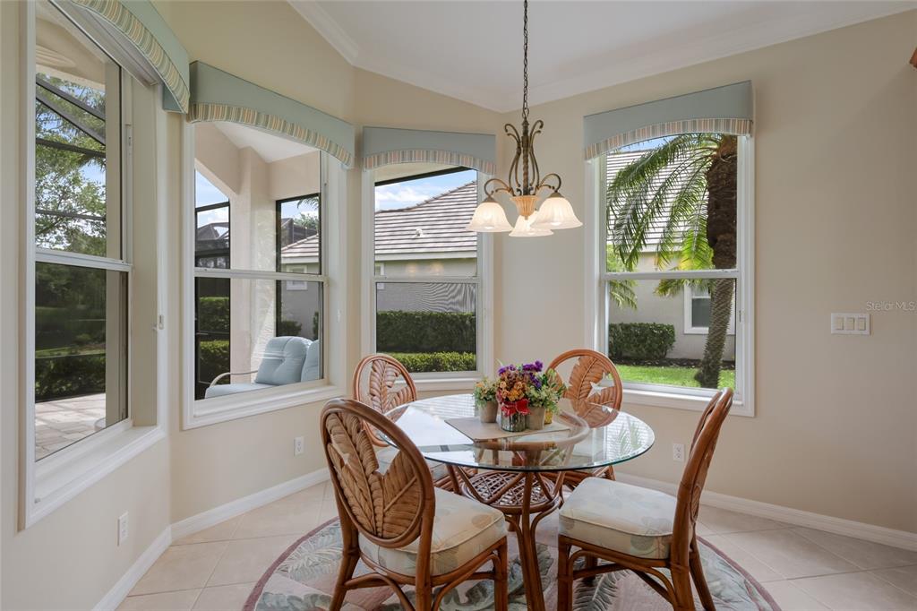 11709 Strandhill Court Lakewood Ranch, FL 34202 - Photo 17 of 51 a dining room with furniture window and outside view