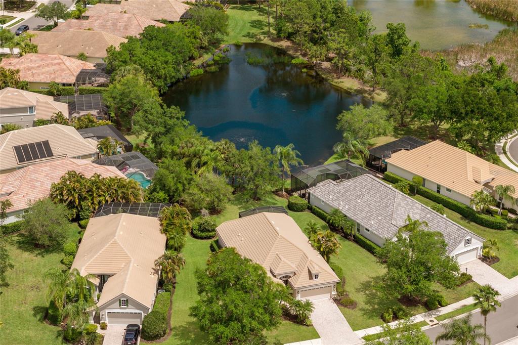 11709 Strandhill Court Lakewood Ranch, FL 34202 - Photo 31 of 51 an aerial view of a house with outdoor space and a lake view