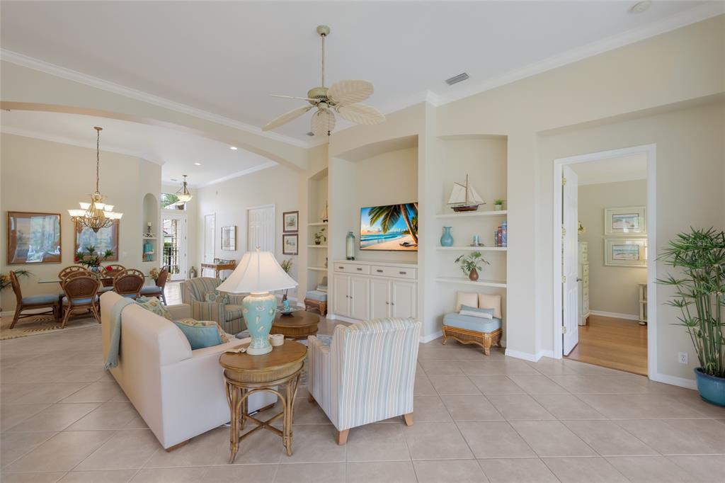 11709 Strandhill Court Lakewood Ranch, FL 34202 - Photo 8 of 51 a living room with furniture and a chandelier
