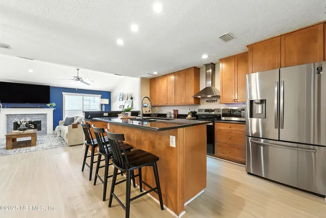 a kitchen with stainless steel appliances granite countertop counter space a sink and a refrigerator