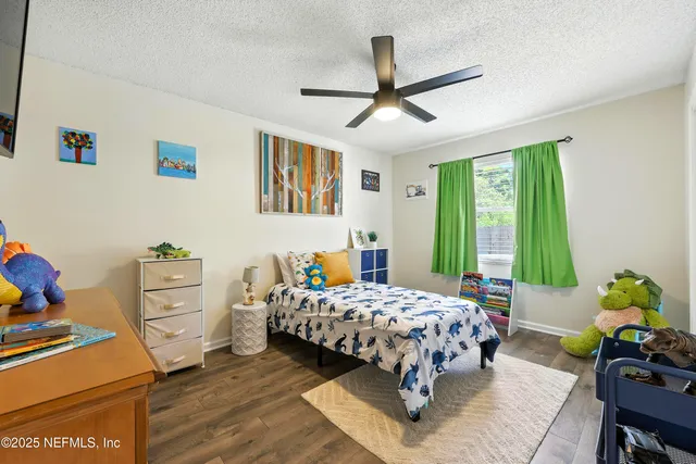 a living room with furniture a flat screen tv and a window