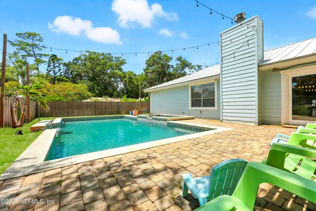 a view of a backyard with swimming pool