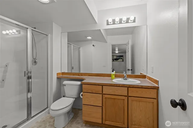 a bathroom with a toilet sink shower and mirror