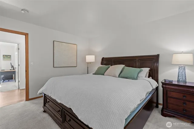 a bedroom with a bed and a lamp