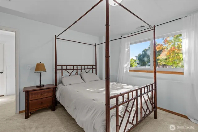 a bedroom with a bed and a table