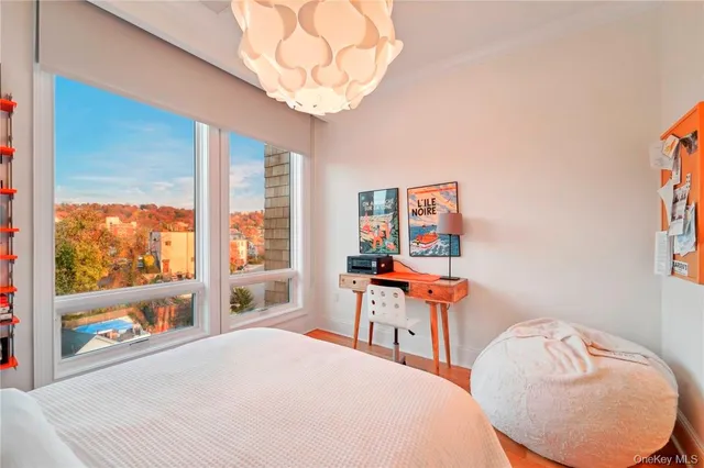 a bedroom with furniture and a large window