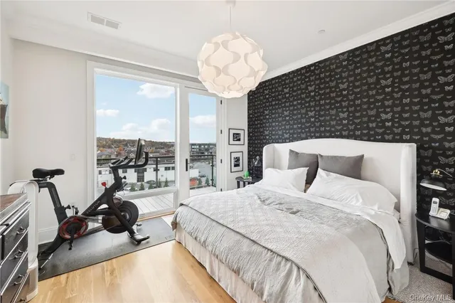 a bedroom with a bed and a large window