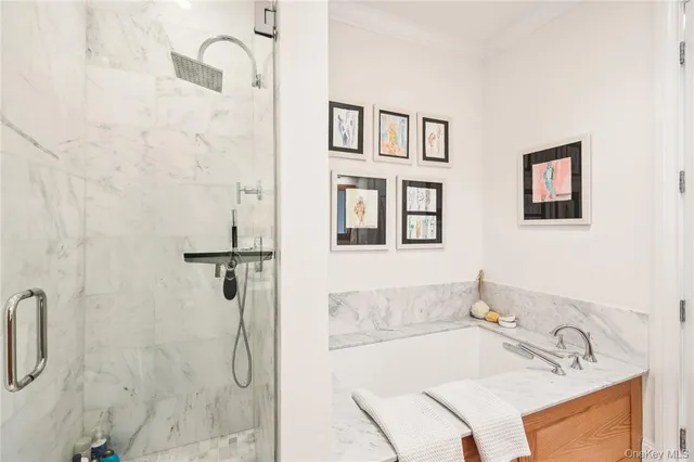 a bathroom with a tub sink and mirror