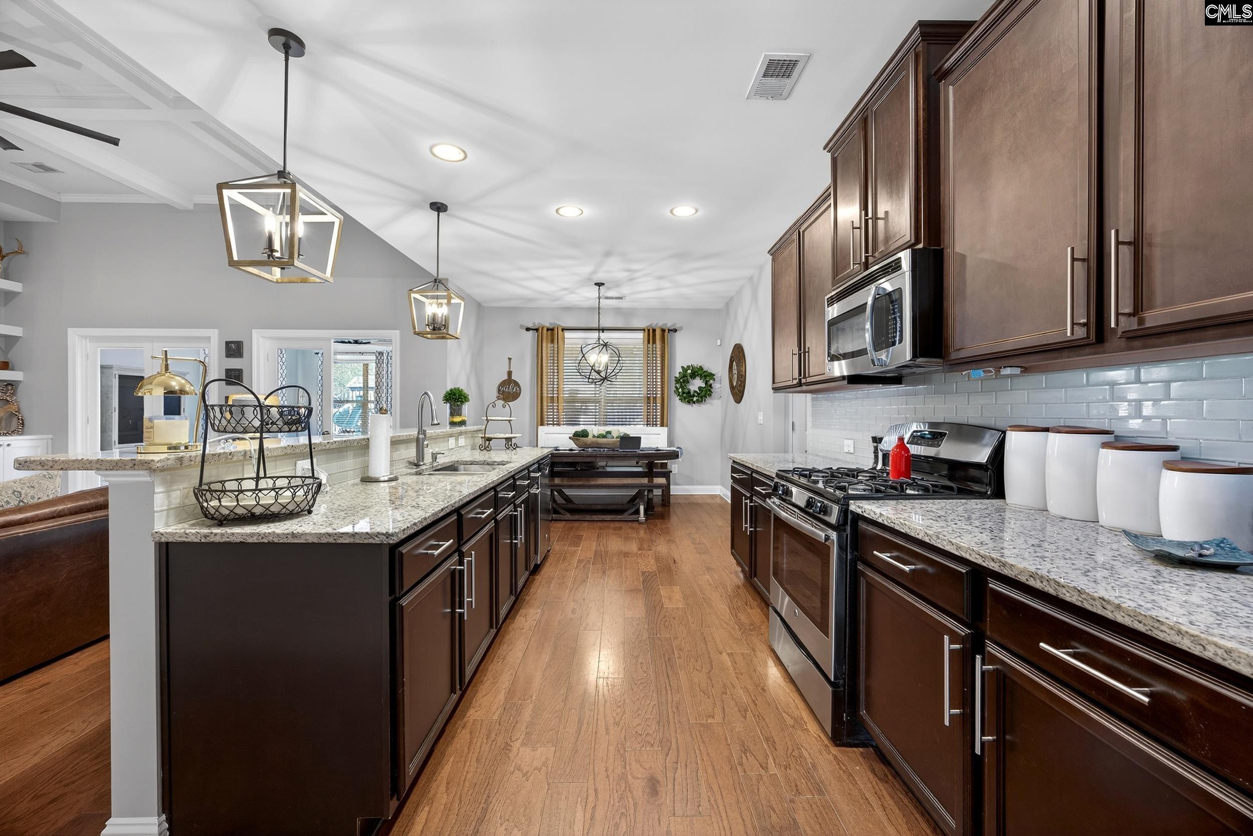 116 Renard Way Gilbert, SC 29054 - Photo 25 of 74 a kitchen with kitchen island granite countertop lots of counter top space a sink and stainless steel appliances