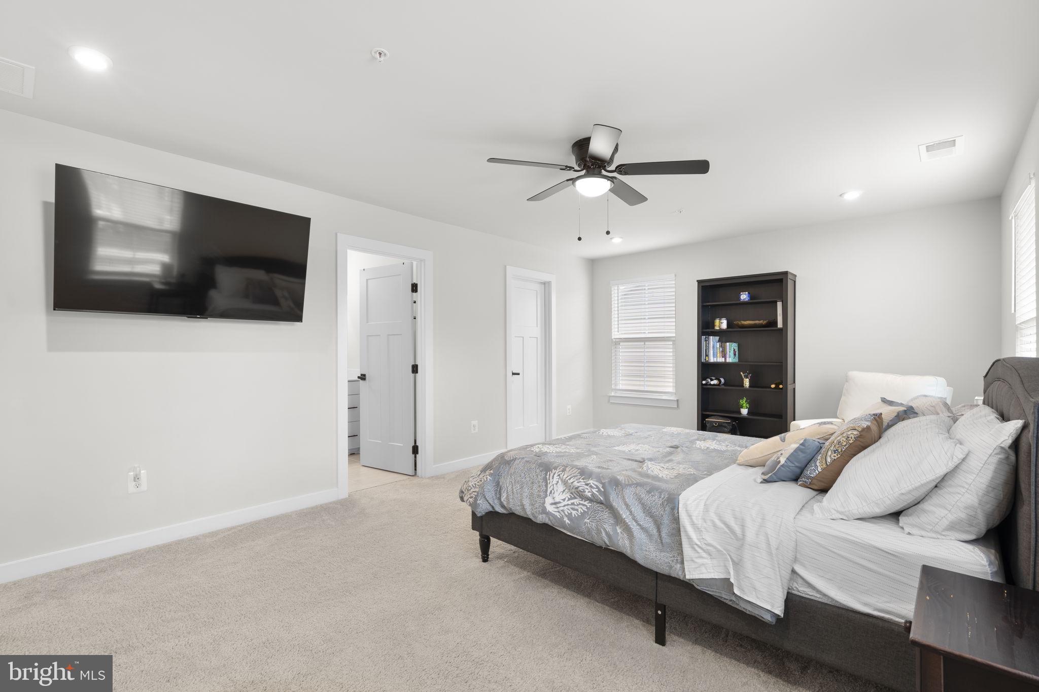 1713 Aurora Way Frederick, MD 21702 - Photo 30 of 57 a bedroom with a large bed and a flat screen tv