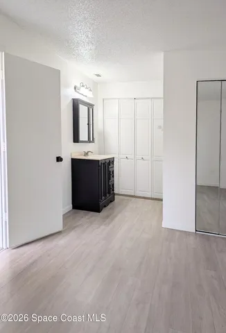 a view of a kitchen with a sink and cabinet