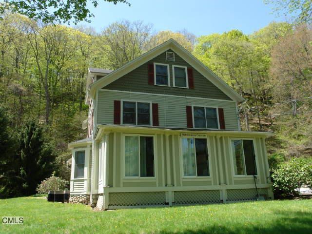 783 Danbury Road, Unit 2B Wilton, CT 06897 - Photo 1 of 1 a front view of a house with a garden