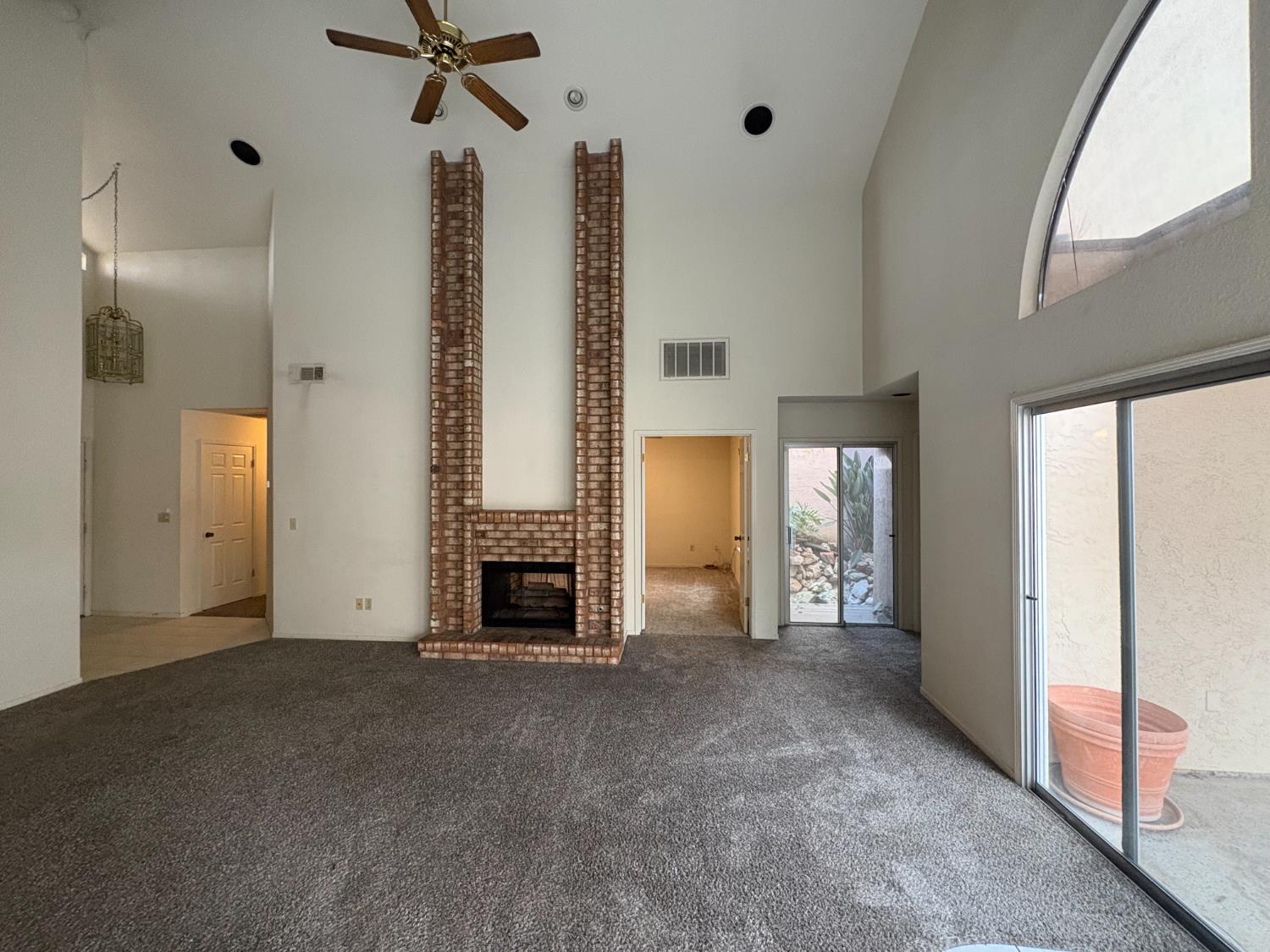 1829 Oak Leaf Drive Modesto, CA 95354 - Photo 7 of 31 a view of an empty room with a fireplace and a window