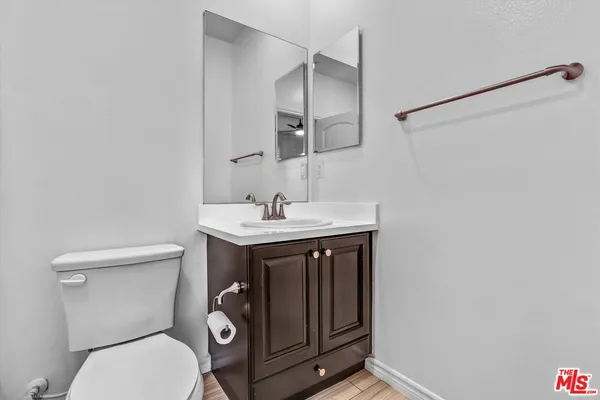 a bathroom with a toilet a sink and mirror