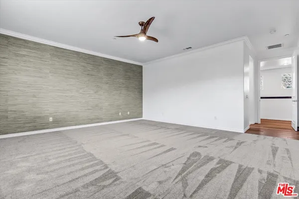 a view of empty room with wooden floor