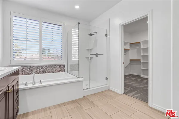 a bathroom with a tub shower and sink