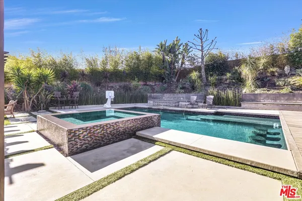 a view of a backyard with swimming pool