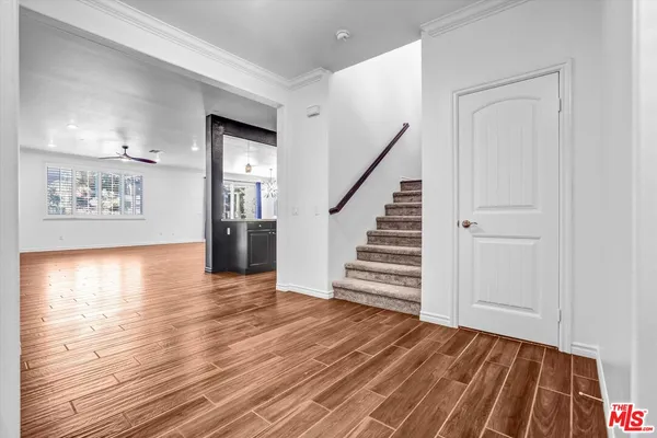 a view of a room with wooden floor and stairs