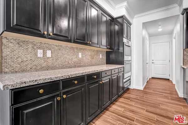 a kitchen with granite countertop stainless steel appliances and wooden cabinets