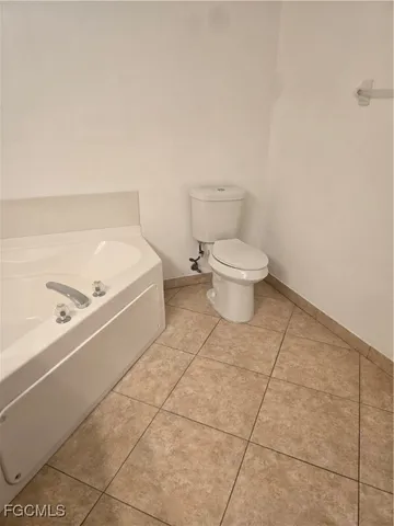a bathroom with a toilet and a bathtub