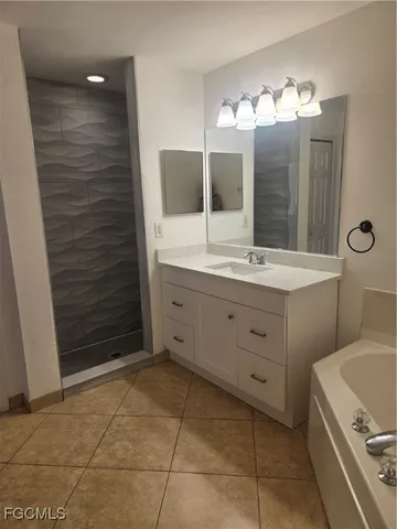 a bathroom with a double vanity sink a toilet a mirror and shower