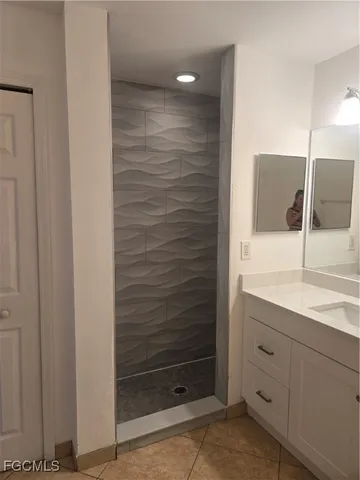 a bathroom with a shower and a sink