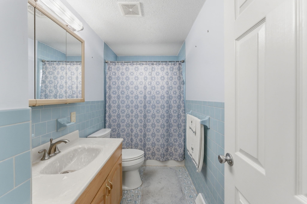 76 Lake Street Pawtucket, RI 02860 - Photo 11 of 18 a bathroom with a granite countertop sink toilet and shower
