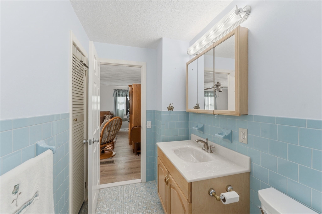 76 Lake Street Pawtucket, RI 02860 - Photo 12 of 18 a bathroom with a sink a toilet and mirror