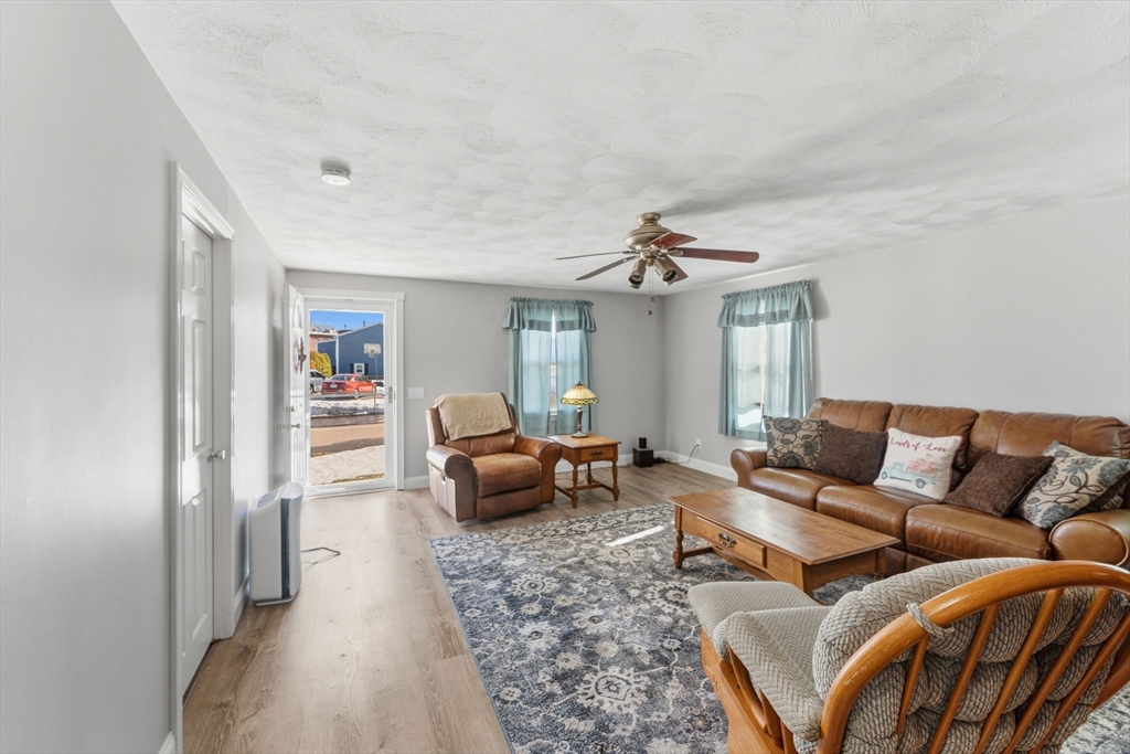 76 Lake Street Pawtucket, RI 02860 - Photo 4 of 18 a living room with furniture ceiling fan and a rug