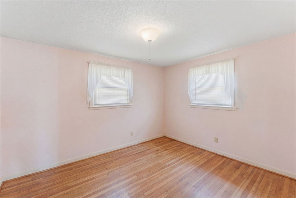 76 Lake Street Pawtucket, RI 02860 - Photo 10 of 18 an empty room with wooden floor and windows