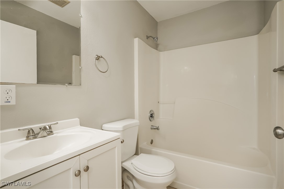 16981 First Street Alva, FL 33920 - Photo 11 of 16 a bathroom with a sink a toilet and shower