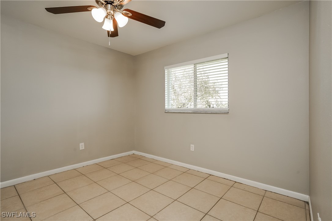 16981 First Street Alva, FL 33920 - Photo 12 of 16 an empty room with a chandelier fan