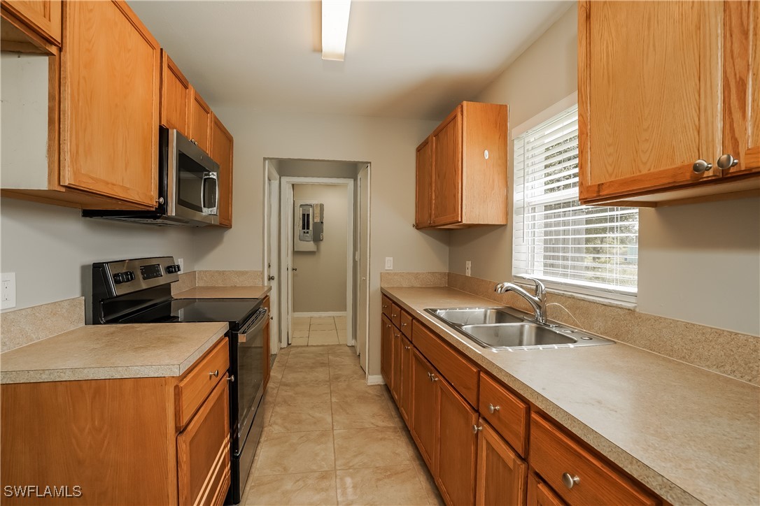 16981 First Street Alva, FL 33920 - Photo 7 of 16 a kitchen that has a sink and a stove