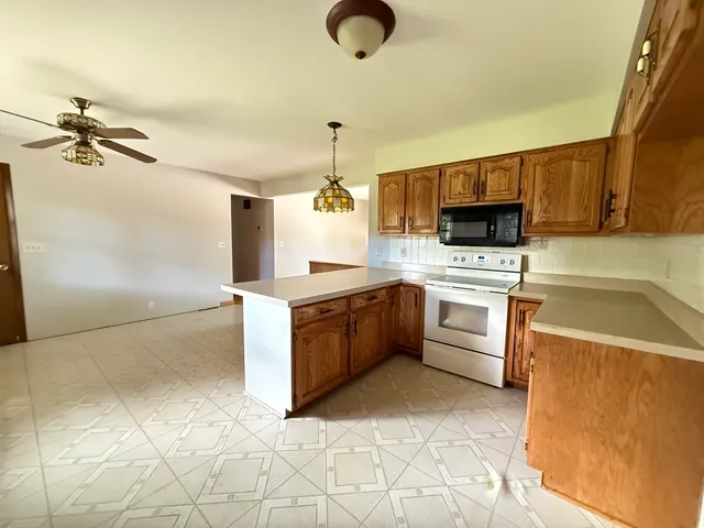 a kitchen with a sink appliances and cabinets