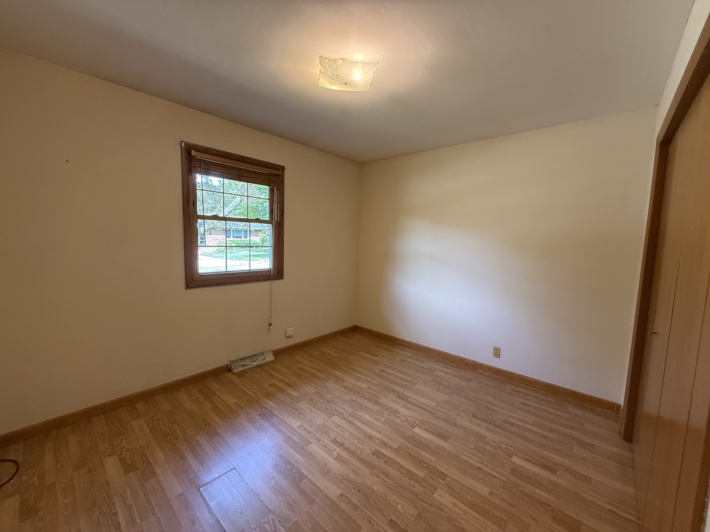 1029 West 4th Street Spring Valley, IL 61362 - Photo 16 of 27 an empty room with wooden floor and windows