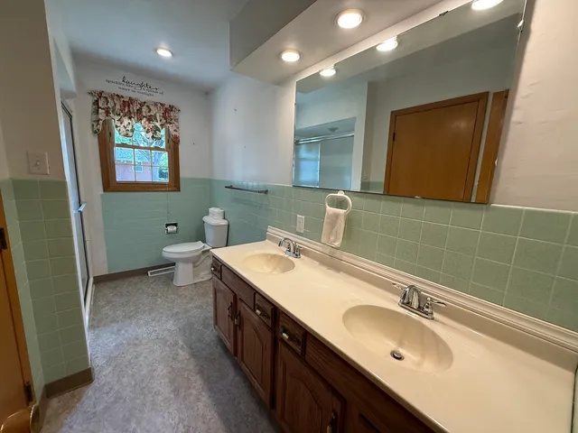 a bathroom with a sink double vanity and a mirror