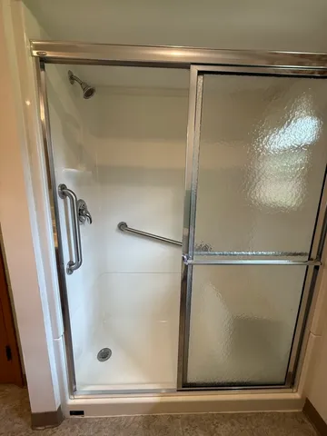 a bathroom with a glass shower door