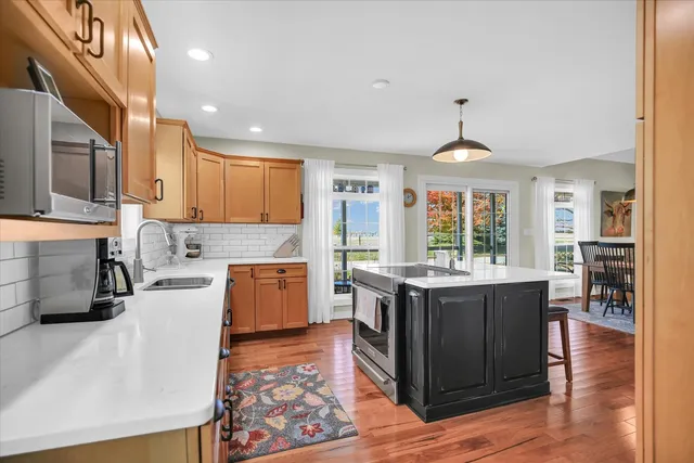 a kitchen with granite countertop a sink stove and refrigerator