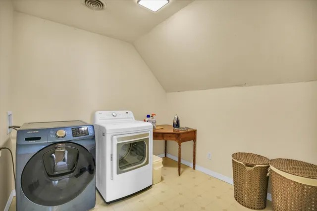 a front view of a house with a lots of flower plants