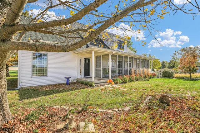 a view of a house with a yard and sitting area
