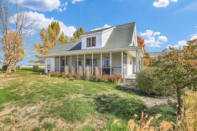a brick house with garden in front of it