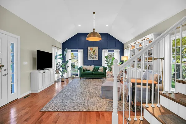 a view of a dining room with furniture wooden floor and chandelier