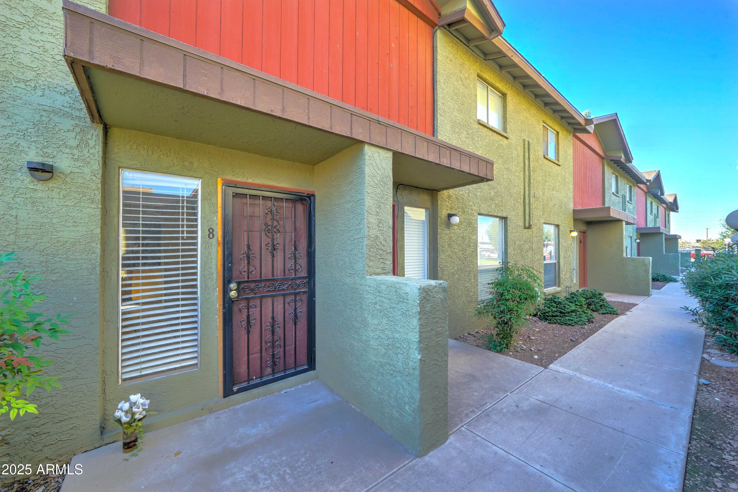 4615 North 39th Avenue, Unit 8 Phoenix, AZ 85019 - Photo 1 of 21 a front view of a house with garden