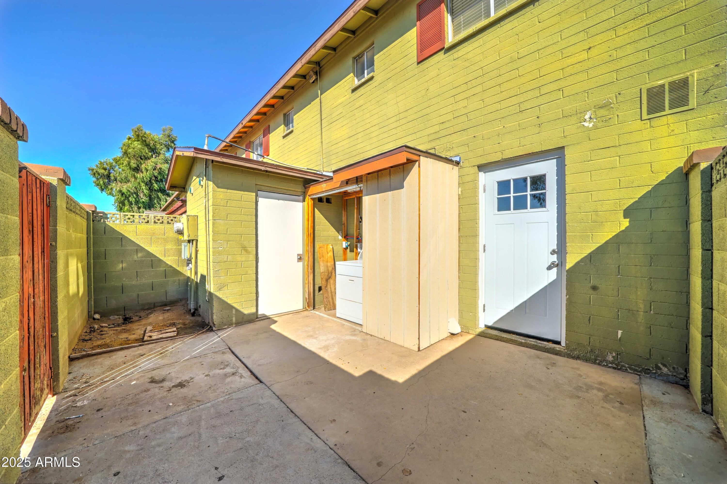 4615 North 39th Avenue, Unit 8 Phoenix, AZ 85019 - Photo 19 of 21 a view of a house with a backyard