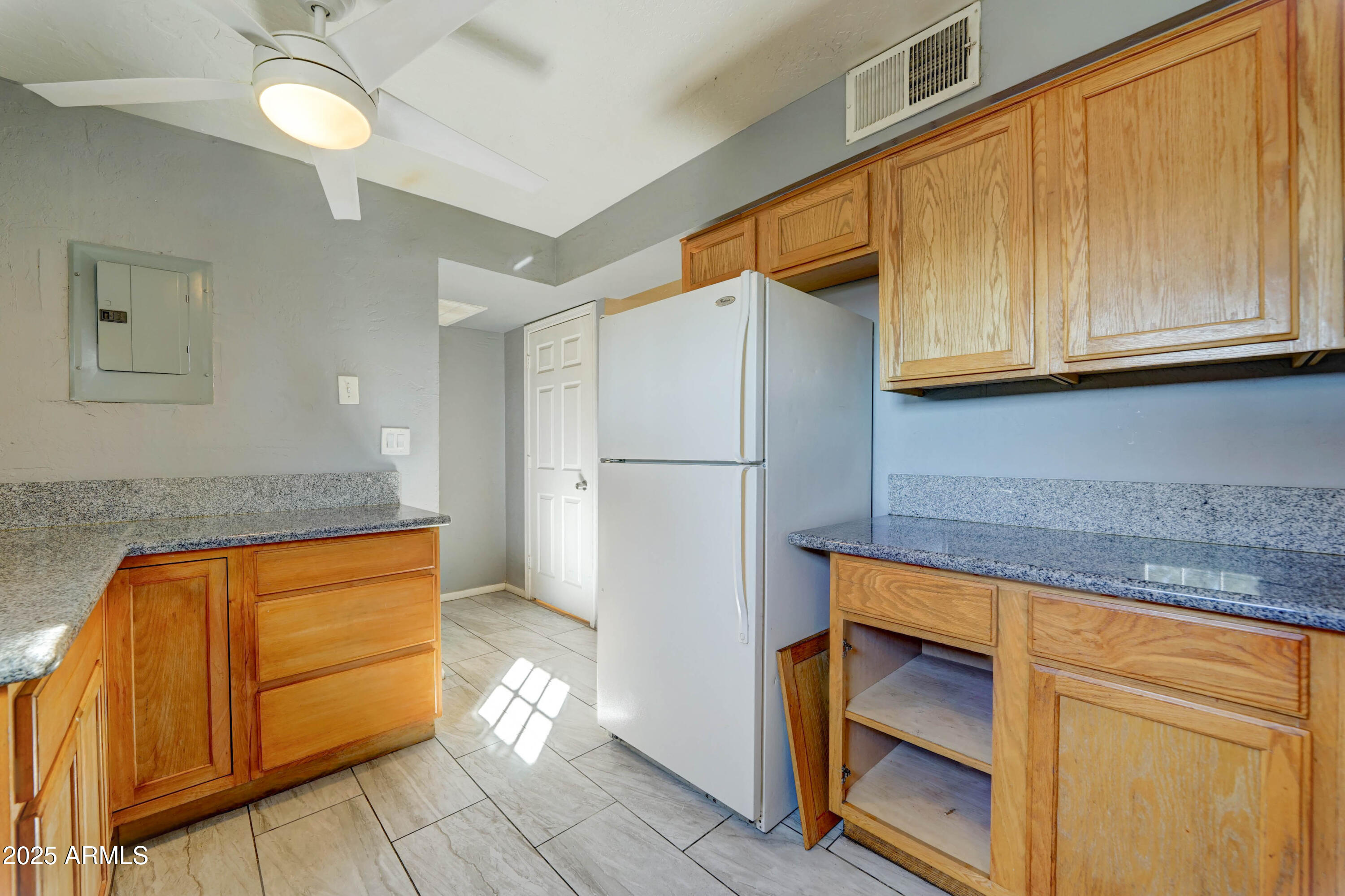 4615 North 39th Avenue, Unit 8 Phoenix, AZ 85019 - Photo 7 of 21 a kitchen with stainless steel appliances granite countertop a refrigerator and a stove top oven