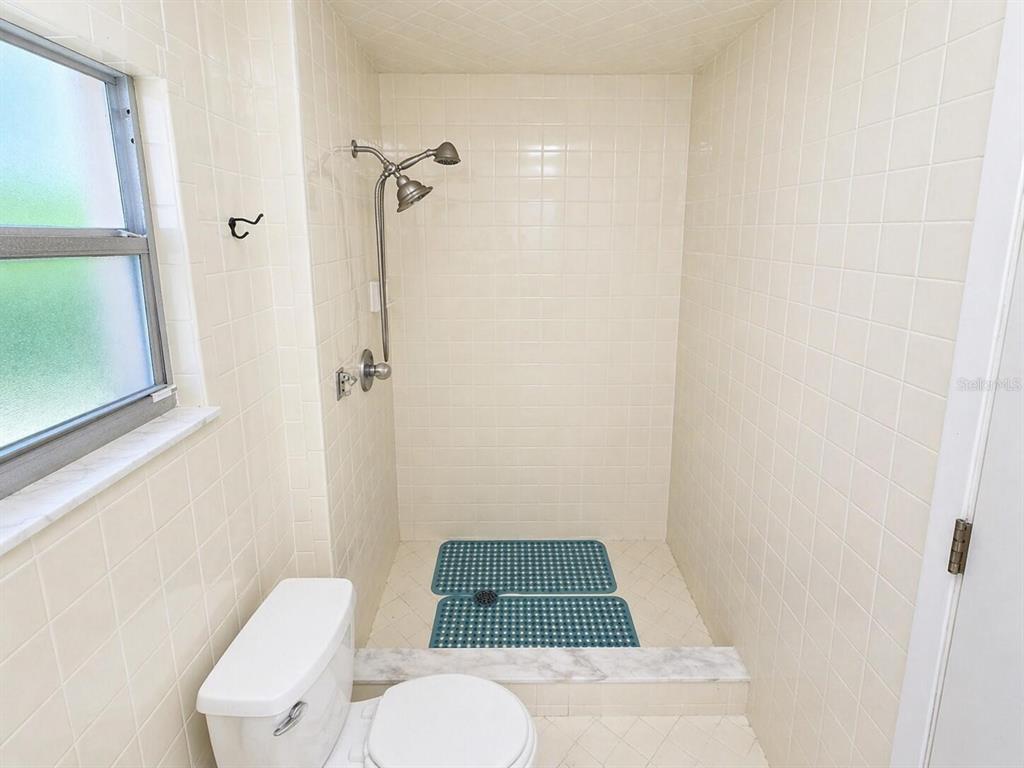 2313 Southeast 7th Street Ocala, FL 34471 - Photo 46 of 54 a bathroom with a toilet and a shower