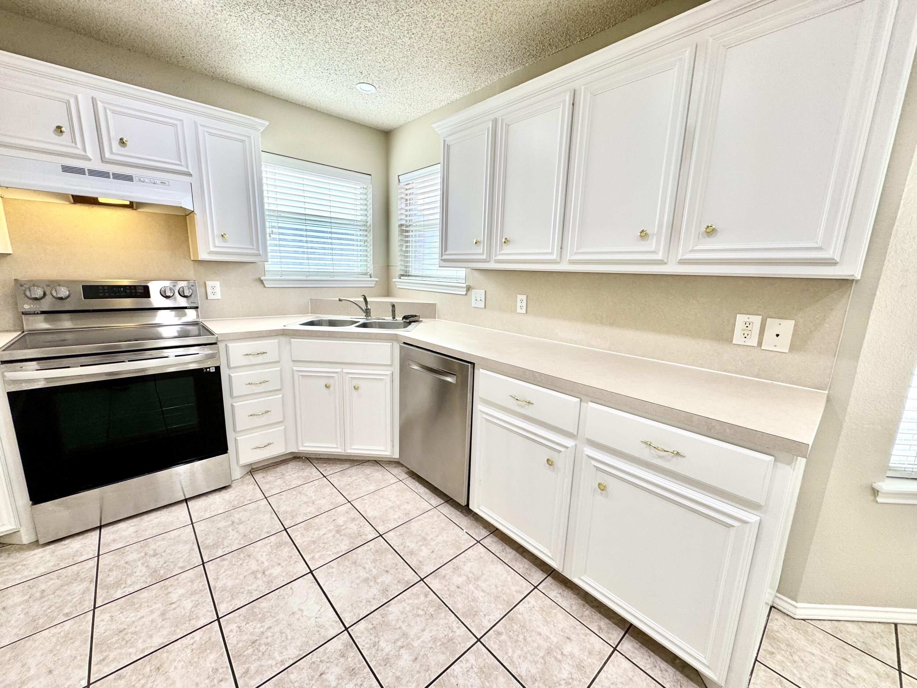 6536 7th Street Lubbock, TX 79416 - Photo 7 of 20 a kitchen with cabinets appliances and a window