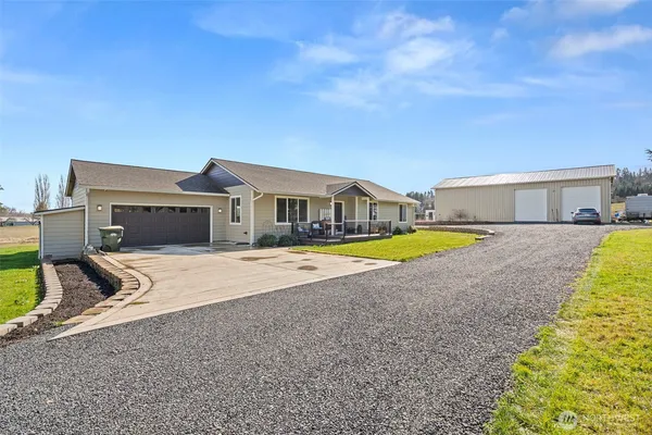 a view of a house with backyard and fence